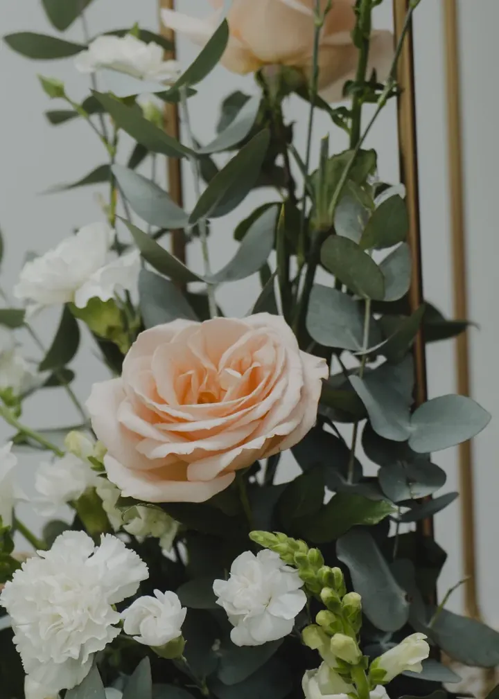 Arreglo con rosa durazno, flores blancas y eucalipto